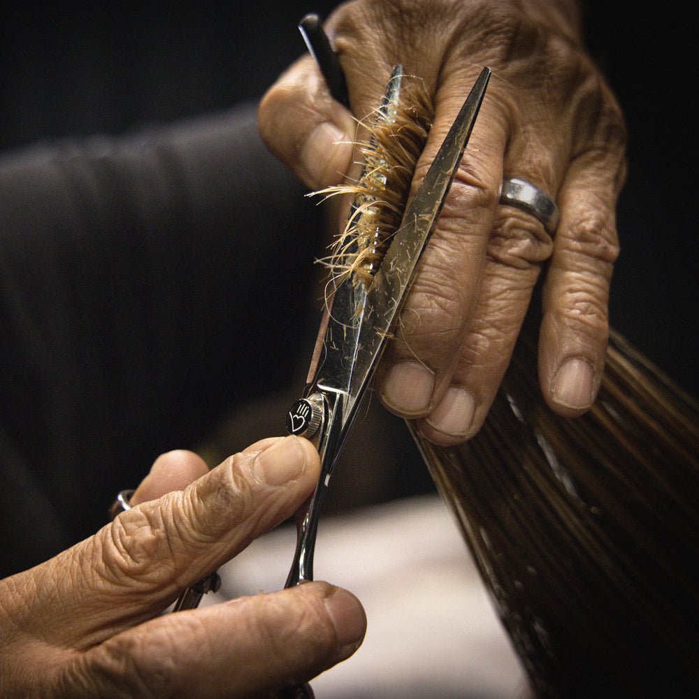 Sam Villa Signature Series Wet Cutting Shear with ergonomic crane handle and forward-set thumb, handcrafted Japanese convex blades, and True Balance ball bearing tension system for smooth, precise wet or dry hair cutting by professional stylists.