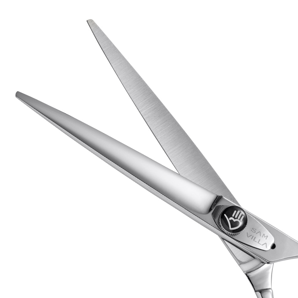 Close-up view of Sam Villa hair cutting shears with stainless steel blades and ergonomic handle, designed for precision hair cutting. Sam Villa Ergonomic Japanese Steel Professional Hair Cutting Shears with Convex Edge Blades.