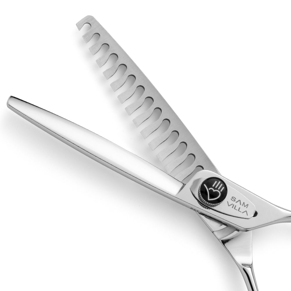 Close-up of Sam Villa tooth point cutting shears, featuring a sleek stainless steel design with precision notched teeth for hair thinning and texturizing.