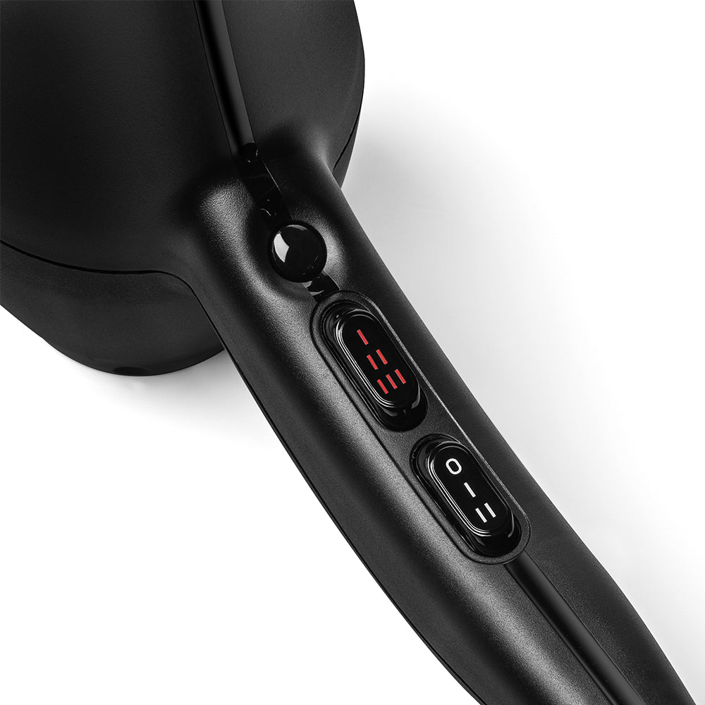Close-up view of the handle and control switches on a Sam Villa Essentials Blow Dryer, showing the heat and power settings