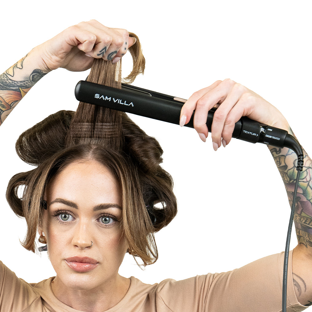 Brunette model with tattoos styling hair with Sam Villa TEXTUR® Professional Texturizing Iron